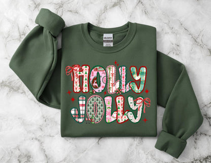 May include: A dark green sweatshirt with the words "HOLLY JOLLY" in a colorful, festive design. The letters are decorated with patterns including plaid, Christmas trees, and bows. Red stars and bows accent the text, creating a holiday theme.