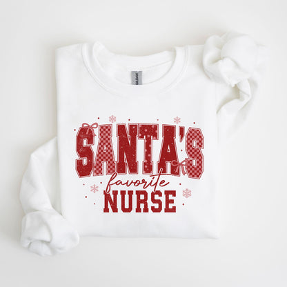 May include: White crewneck sweatshirt with the text "SANTA'S favorite NURSE" in red. The text has a checkered pattern and is decorated with snowflakes and bows. A festive holiday-themed garment.