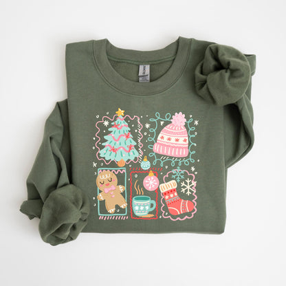 May include: Olive green sweatshirt with a festive Christmas design. The graphic includes a Christmas tree, a pink hat, a gingerbread man, a mug of hot cocoa, and a Christmas stocking. The design is outlined in a pink and white border.