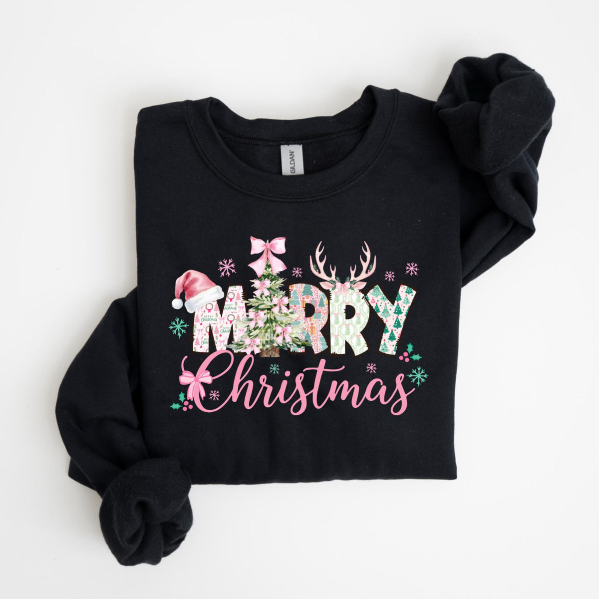 May include: Black crewneck sweatshirt with the words "Merry Christmas" in pink script and decorative letters. The design includes a Christmas tree, snowflakes, a Santa hat, and reindeer antlers. The letters are filled with floral and patterned designs.