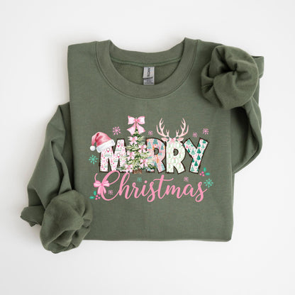 May include: Olive green sweatshirt with a festive "Merry Christmas" design. The graphic includes a Christmas tree, reindeer antlers, snowflakes, and a Santa hat. The text is in pink and white, creating a holiday theme.