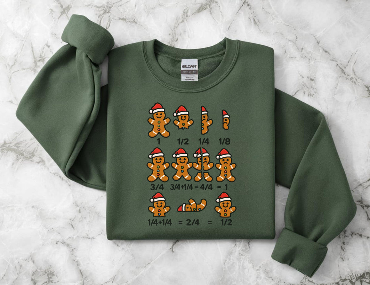 May include: Green sweatshirt featuring gingerbread men with Santa hats and fractions. The design includes the numbers 1, 1/2, 1/4, and 1/8, along with equations like 3/4 + 1/4 = 1 and 1/4 + 1/4 = 1/2. The sweatshirt has a crew neck and long sleeves.