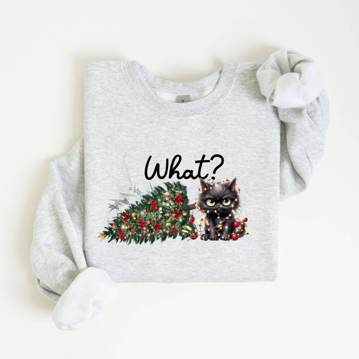 May include: Light gray sweatshirt with a graphic of a black cat tangled in Christmas lights next to a fallen Christmas tree. The word "What?" is written above the cat and tree.