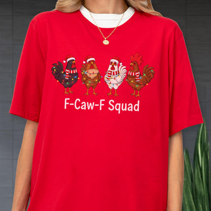 May include: Red t-shirt with a white crew neck featuring four cartoon chickens wearing Santa hats and Christmas lights. The text "F-Caw-F Squad" is printed in white below the chickens. The shirt is a festive holiday design.