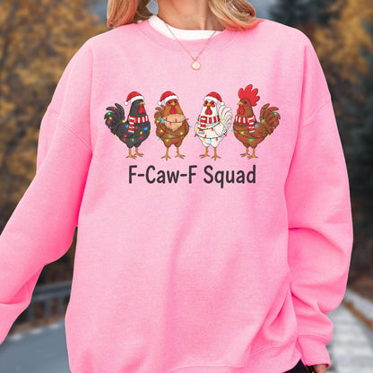 May include: A bright pink sweatshirt featuring a graphic of four cartoon chickens wearing Santa hats and Christmas lights. The text "F-Caw-F Squad" is printed below the chickens. The sweatshirt has a crew neck.