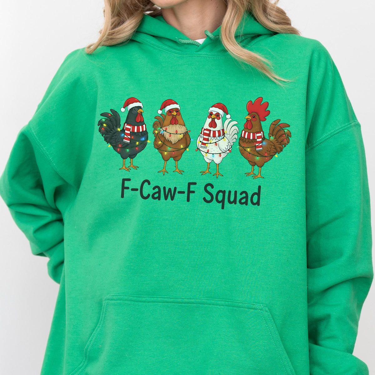 May include: Green hooded sweatshirt featuring a graphic of four cartoon chickens wearing Santa hats and Christmas lights. The text "F-Caw-F Squad" is printed below the chickens. The sweatshirt is made of a soft material.