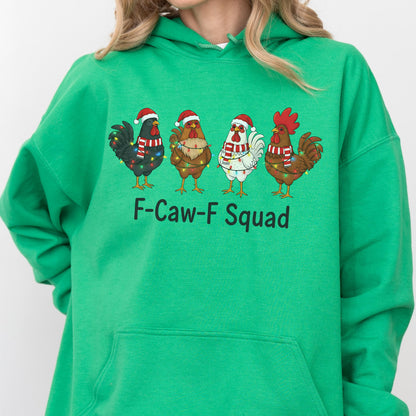 May include: Green hooded sweatshirt featuring a graphic of four cartoon chickens wearing Santa hats and Christmas lights. The text "F-Caw-F Squad" is printed below the chickens. The sweatshirt is made of a soft material.
