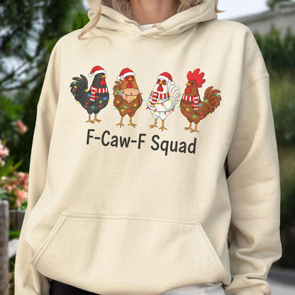 May include: A beige hoodie featuring four cartoon roosters wearing Santa hats and Christmas lights. The roosters are in various colors: black, brown, white, and red. The text "F-Caw-F Squad" is printed below the roosters.