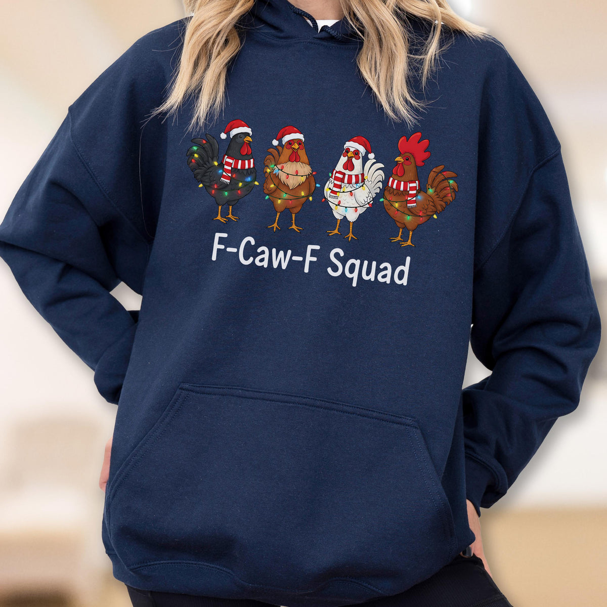 May include: Navy blue hooded sweatshirt featuring four cartoon chickens wearing Santa hats and Christmas lights. The text "F-Caw-F Squad" is printed below the chickens. A festive and humorous design.