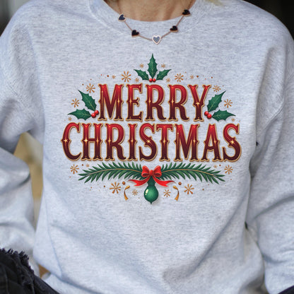 May include: A light gray sweatshirt with the words "MERRY CHRISTMAS" in a festive, ornate font. The design includes holly leaves, berries, and a red bow, creating a holiday theme. The sweatshirt is a comfortable, casual style.