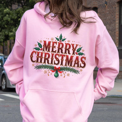 May include: A light pink hoodie with a front pocket and a hood. The back of the hoodie features the words "MERRY CHRISTMAS" in a festive design with red and green accents, holly leaves, and a bow.