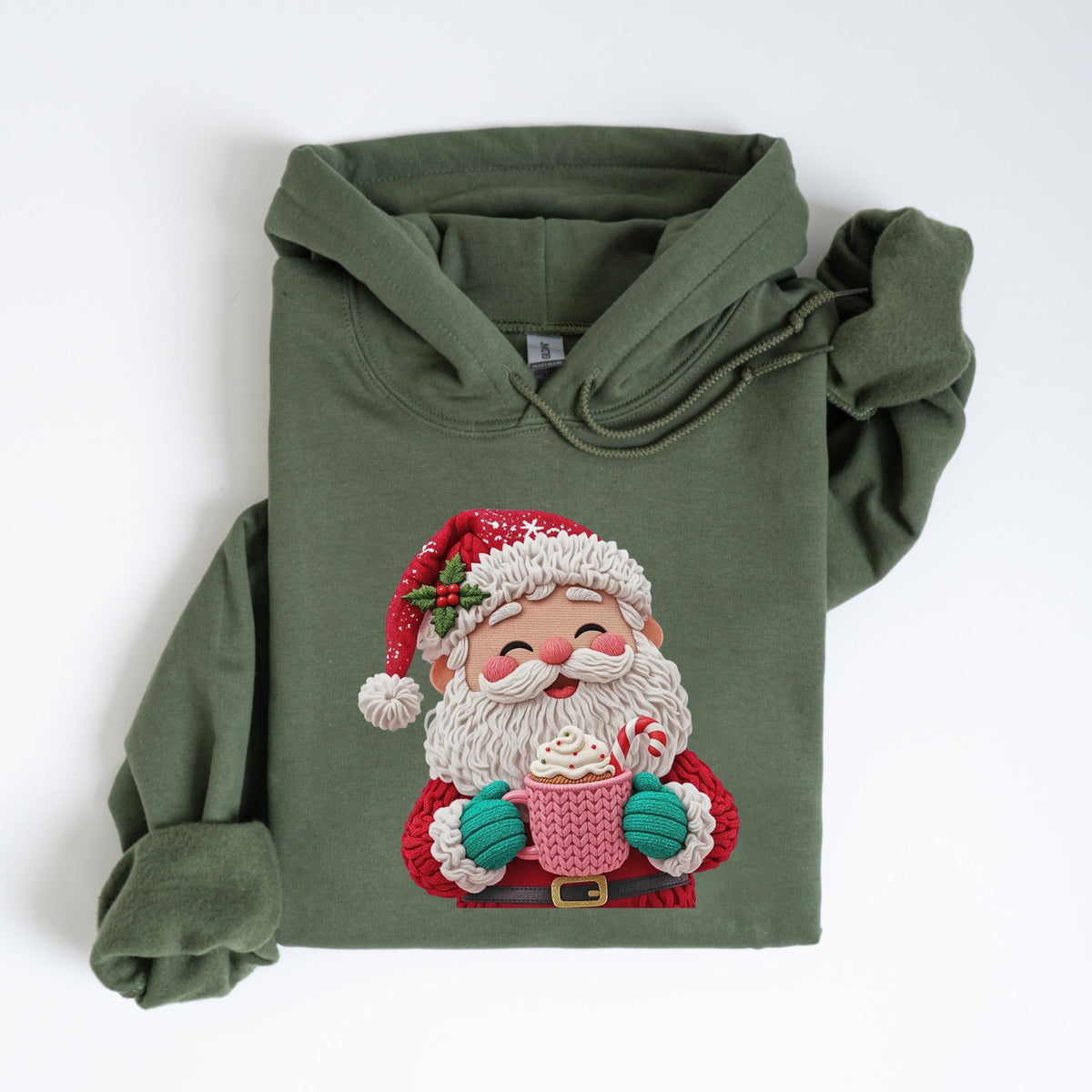 May include: Olive green hooded sweatshirt featuring a Santa Claus graphic. The Santa illustration shows a jolly figure in a red hat and coat, holding a pink mug with whipped cream and a candy cane. The sweatshirt has a drawstring hood and long sleeves.
