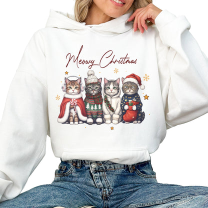 May include: A white hooded sweatshirt featuring a graphic of four cats dressed in winter holiday attire with the text Meowy Christmas. The cats wear accessories including earmuffs, a knit hat, a scarf, and a Santa hat, with small gold stars.