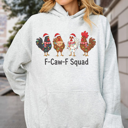 May include: A light gray hoodie featuring a festive design. The graphic shows four chickens, each adorned with Santa hats, scarves, and string lights. The text "F-Caw-F Squad" is printed below the chickens.