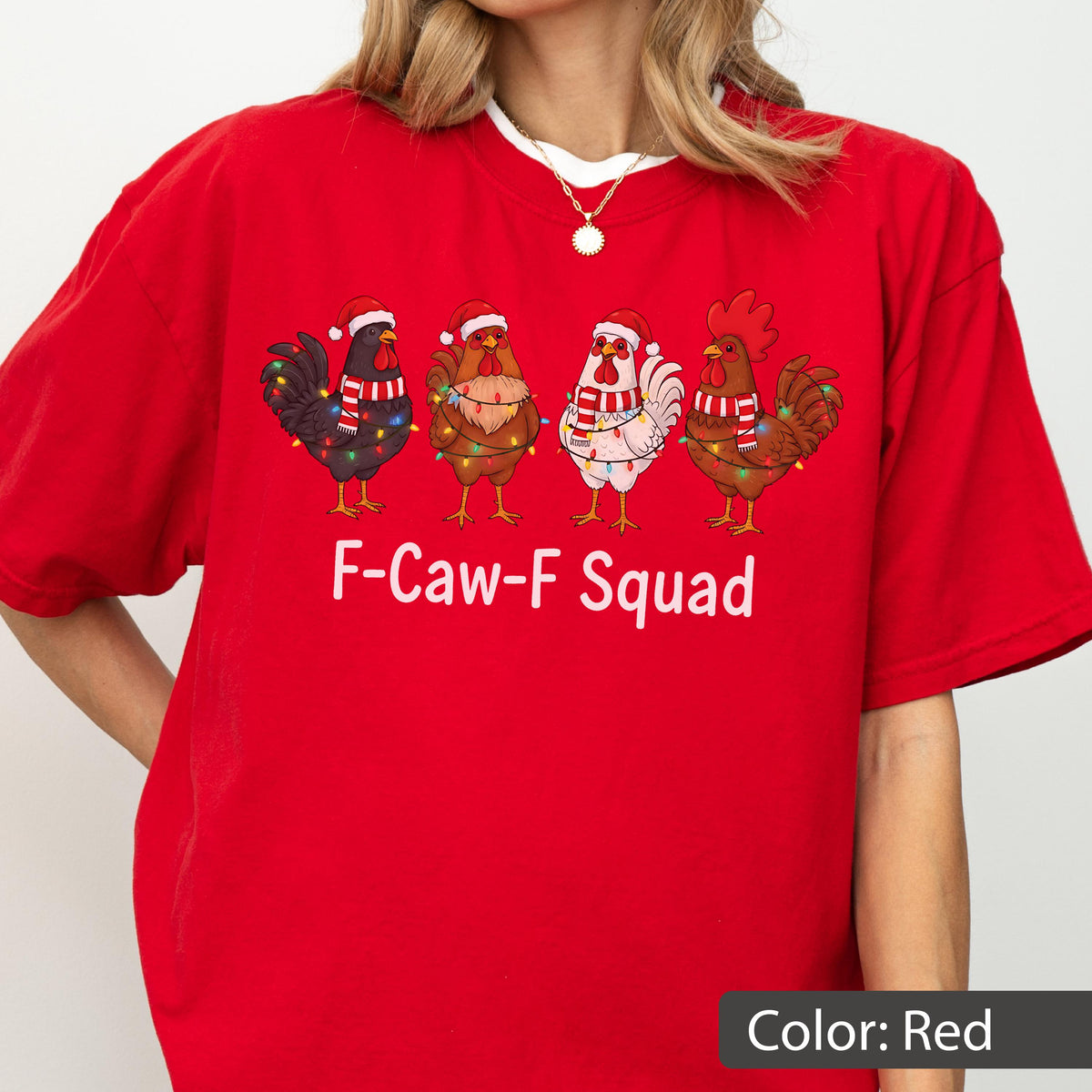 May include: Red t-shirt featuring a festive design with four cartoon roosters wearing Santa hats and scarves, adorned with Christmas lights. The text "F-Caw-F Squad" is printed below the roosters. The shirt is a solid red color.