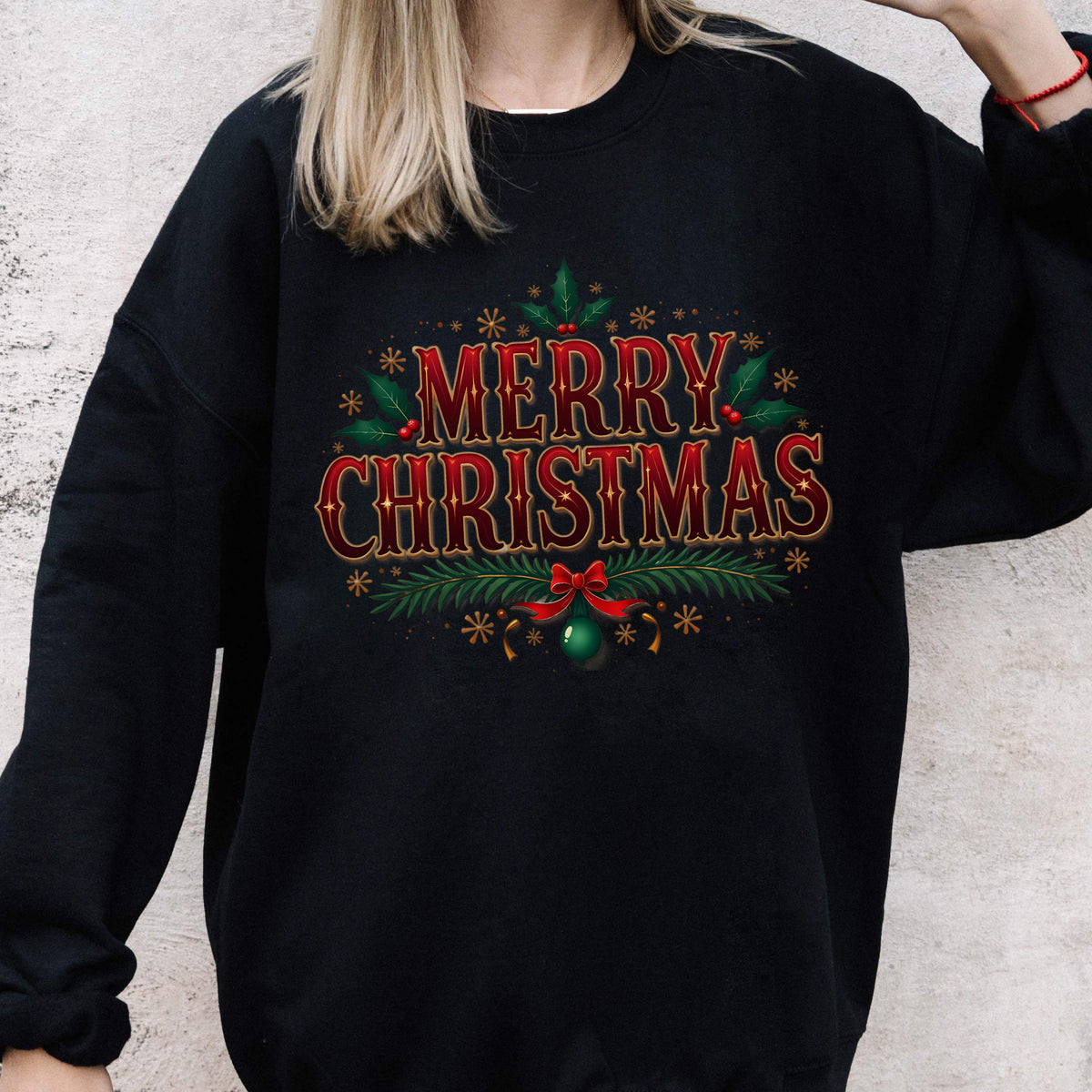 May include: Black sweatshirt with a festive "MERRY CHRISTMAS" design in red and gold. The design includes holly, snowflakes, a green ornament, and a red bow. A holiday-themed apparel item.