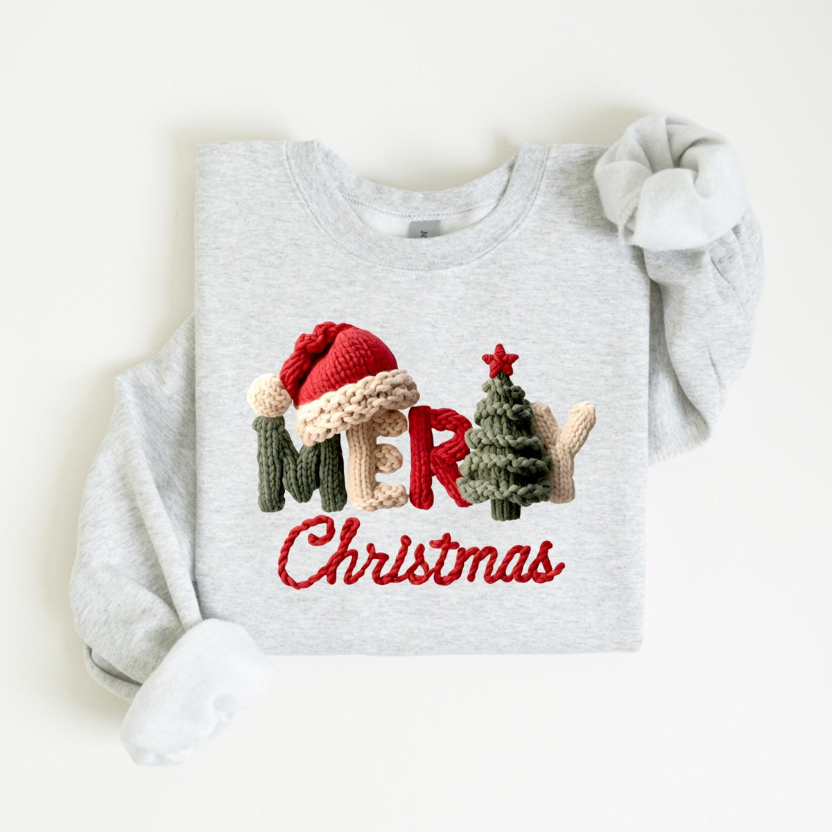 May include: A light gray sweatshirt with the words "MERRY Christmas" embroidered in red, green, beige, and red. The word "MERRY" is designed with a Santa hat, a Christmas tree, and a mitten.