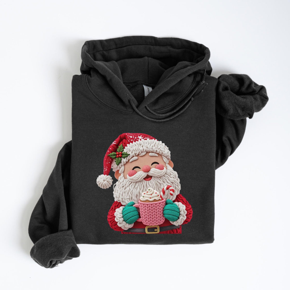May include: Dark gray hoodie featuring a festive Santa Claus graphic. The Santa illustration is holding a pink mug with whipped cream and a candy cane. Santa is wearing a red hat, coat, and belt, with a white beard and green mittens. A cozy holiday-themed sweatshirt.
