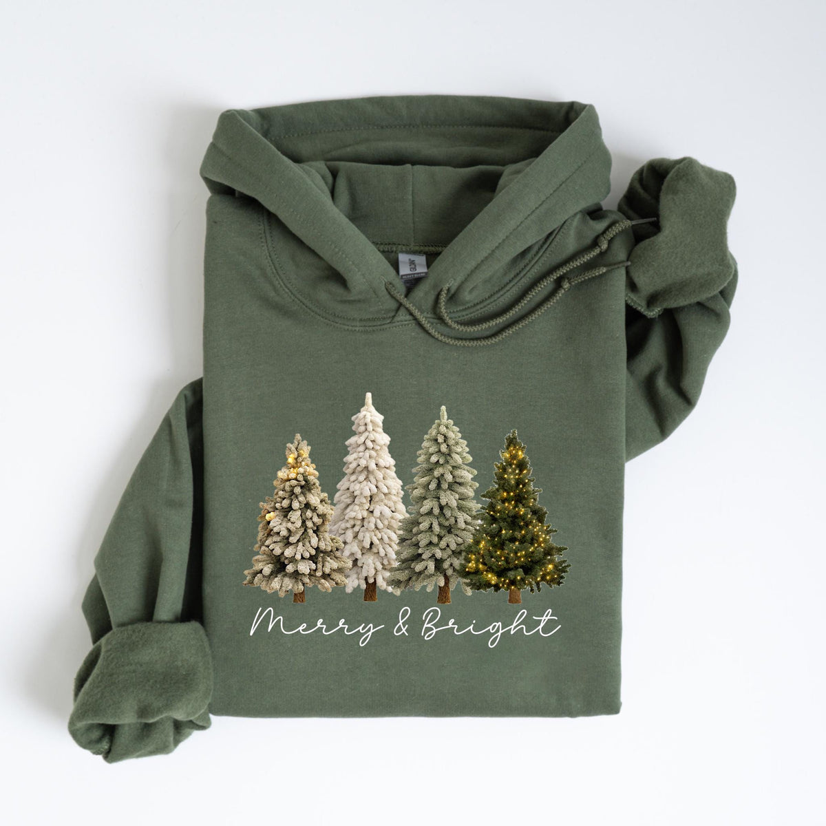 May include: An olive green hoodie featuring a graphic of four Christmas trees in varying styles. The trees are decorated with gold and white accents. The words "Merry & Bright" are written in a cursive font below the trees.