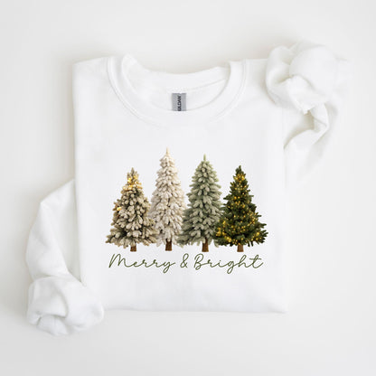 May include: White sweatshirt featuring a graphic of four Christmas trees in varying shades of green and white, with string lights on two trees. The phrase "Merry & Bright" is written in a script font below the trees.