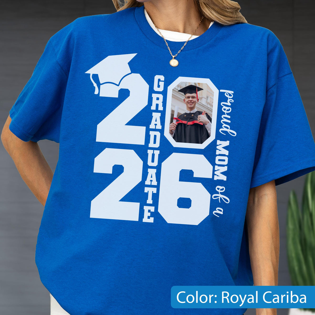 May include: Royal Cariba blue t-shirt with a white graduation cap graphic and the text "2026 Graduate". Includes a photo of a graduate and the text "proud MOM of a".