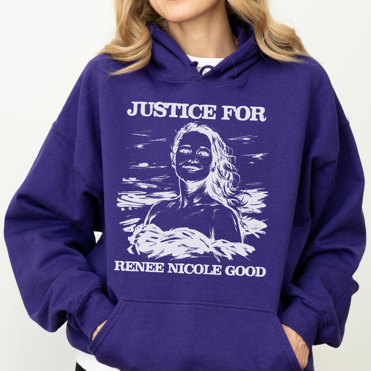 May include: A deep purple hoodie with a white graphic that reads "JUSTICE FOR" above a portrait of a woman, and "RENEE NICOLE GOOD" below. The hoodie has a hood and a front pocket.
