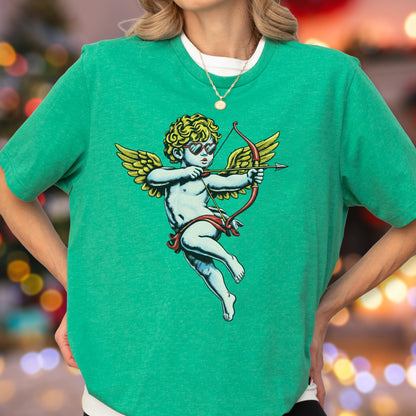 May include: A bright green short-sleeved t-shirt featuring a graphic print of a cherub with golden wings and curly hair, wearing heart-shaped sunglasses and holding a red bow and arrow. The cherub is depicted in a light blue tone.