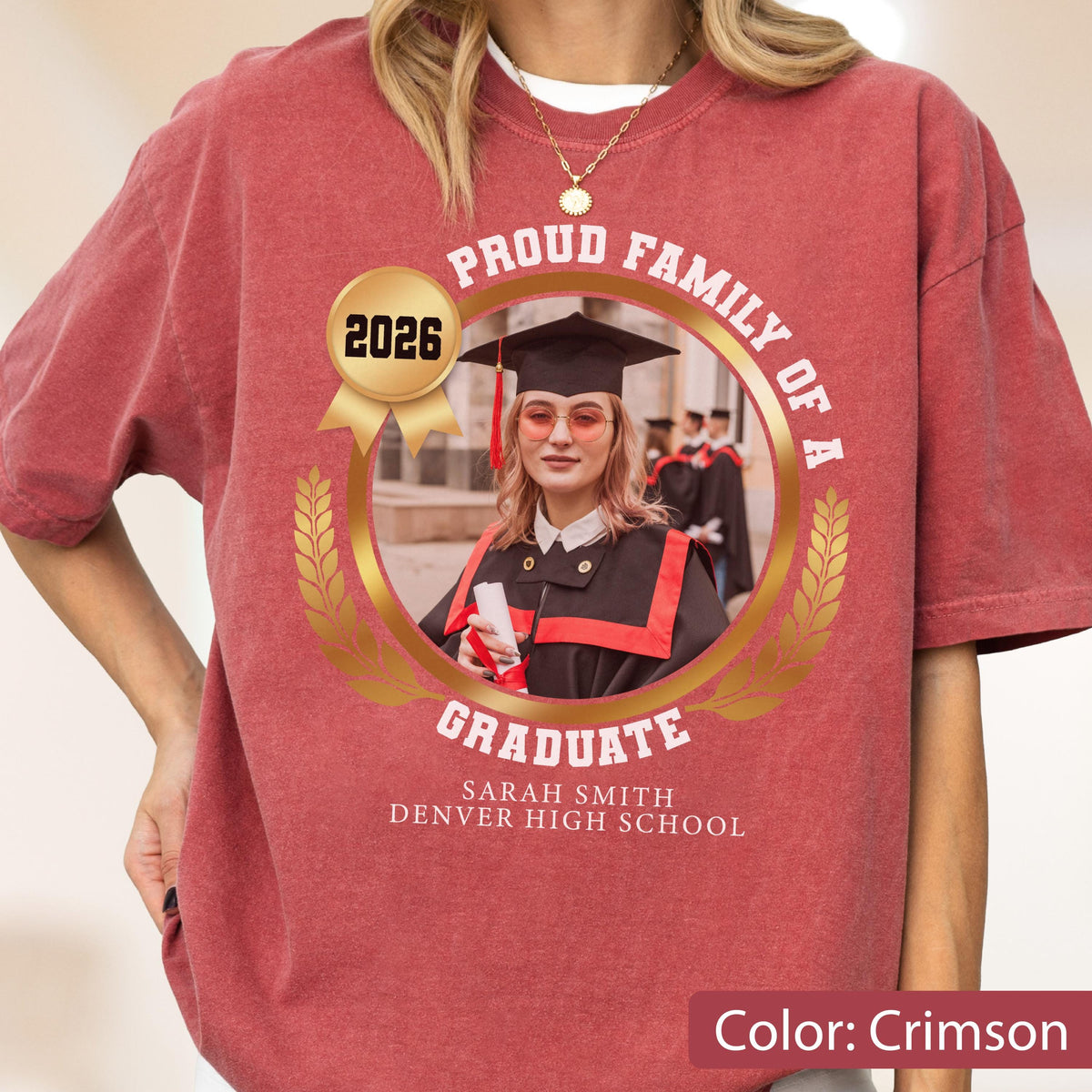 May include: Crimson-colored t-shirt featuring a graduation design. The design includes a photo of a graduate in a cap and gown, the text "Proud Family of a Graduate," the year "2026," and the graduate's name and high school.