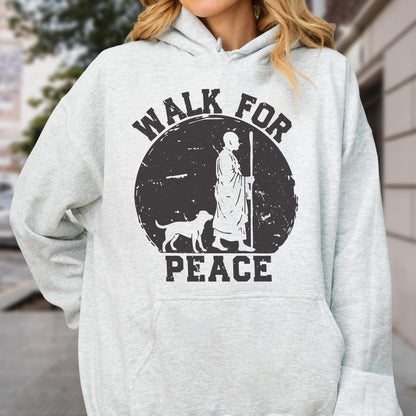 May include: Light gray hoodie with a black graphic. The graphic features a figure with a dog and the words "WALK FOR PEACE" in a circular design. The hoodie has a drawstring hood and a front pocket.