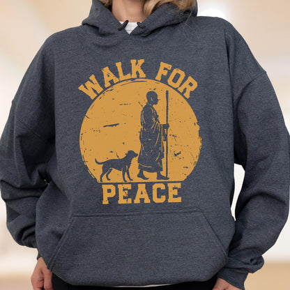 May include: Dark gray hoodie with a graphic featuring a person with a dog walking towards the right, set against a yellow circle. The words "WALK FOR PEACE" are printed above and below the image in a distressed font.