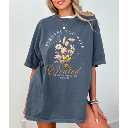 May include: A dark gray t-shirt featuring a floral design with the words "Perhaps You Were Created For Such A Time As This" and the Bible verse Esther 4:14. The design includes various flowers in shades of white, yellow, and pink.