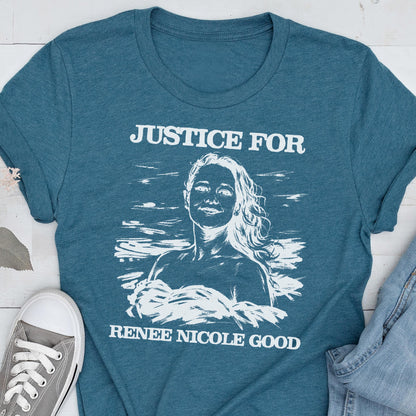 May include: Teal t-shirt with the text "JUSTICE FOR" above a white illustration of a woman and the text "RENEE NICOLE GOOD" below. A gray sneaker is visible in the lower left corner.