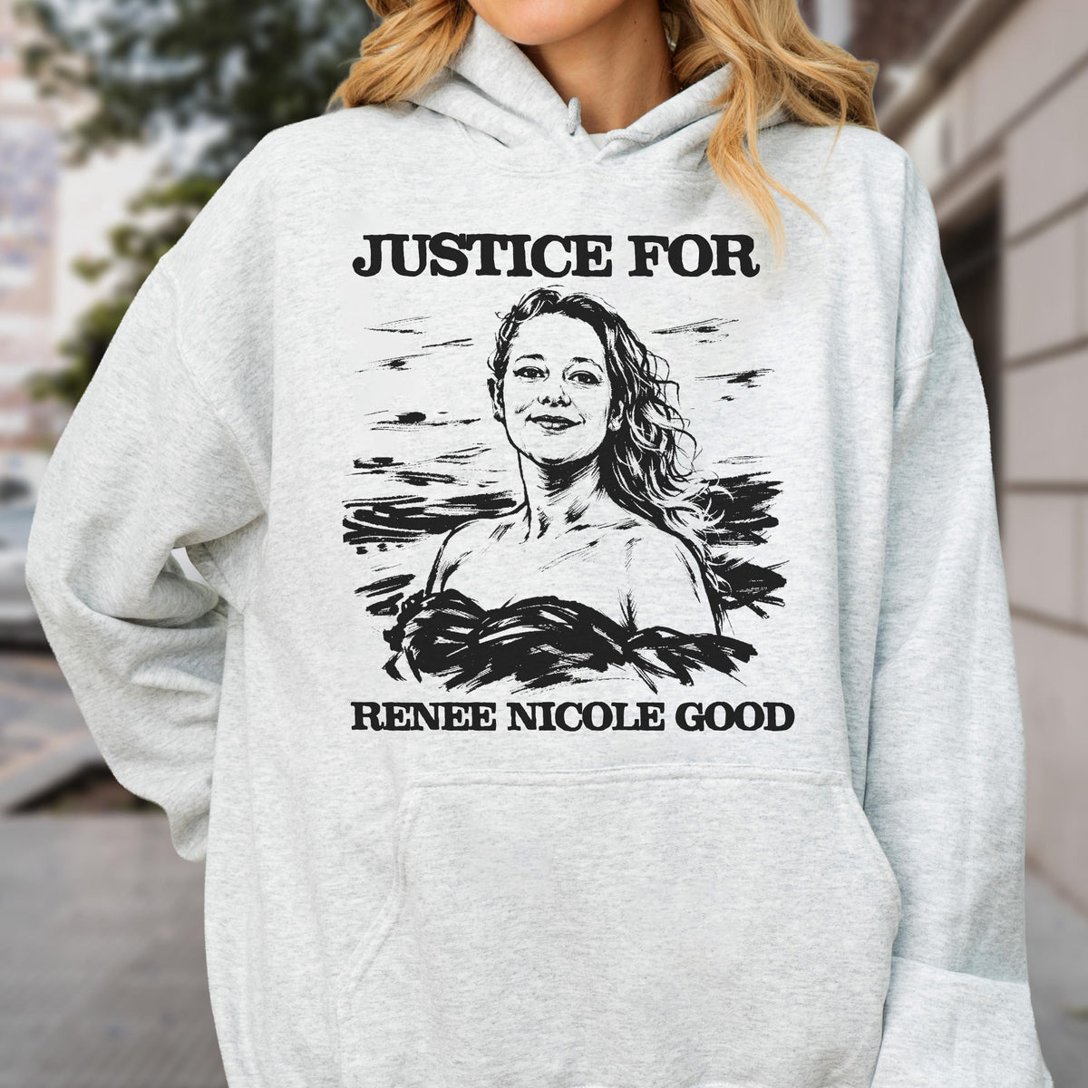 May include: A light gray hoodie featuring a black and white illustration of a woman with the text "JUSTICE FOR" above her and "RENEE NICOLE GOOD" below the illustration.
