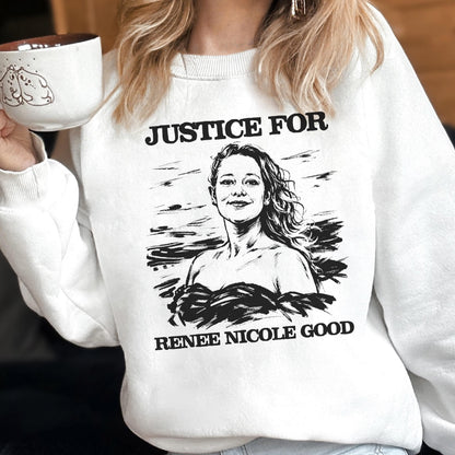 May include: White sweatshirt with the text "JUSTICE FOR" above a black and white illustration of a woman, and the text "RENEE NICOLE GOOD" below. The person is holding a white mug with a brown interior and a cartoon drawing.