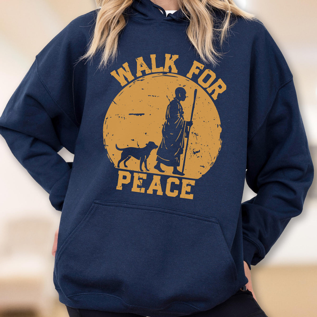 May include: Navy blue hooded sweatshirt with a graphic of a person walking with a dog and staff inside a yellow circle. The words "WALK FOR PEACE" are printed in yellow.