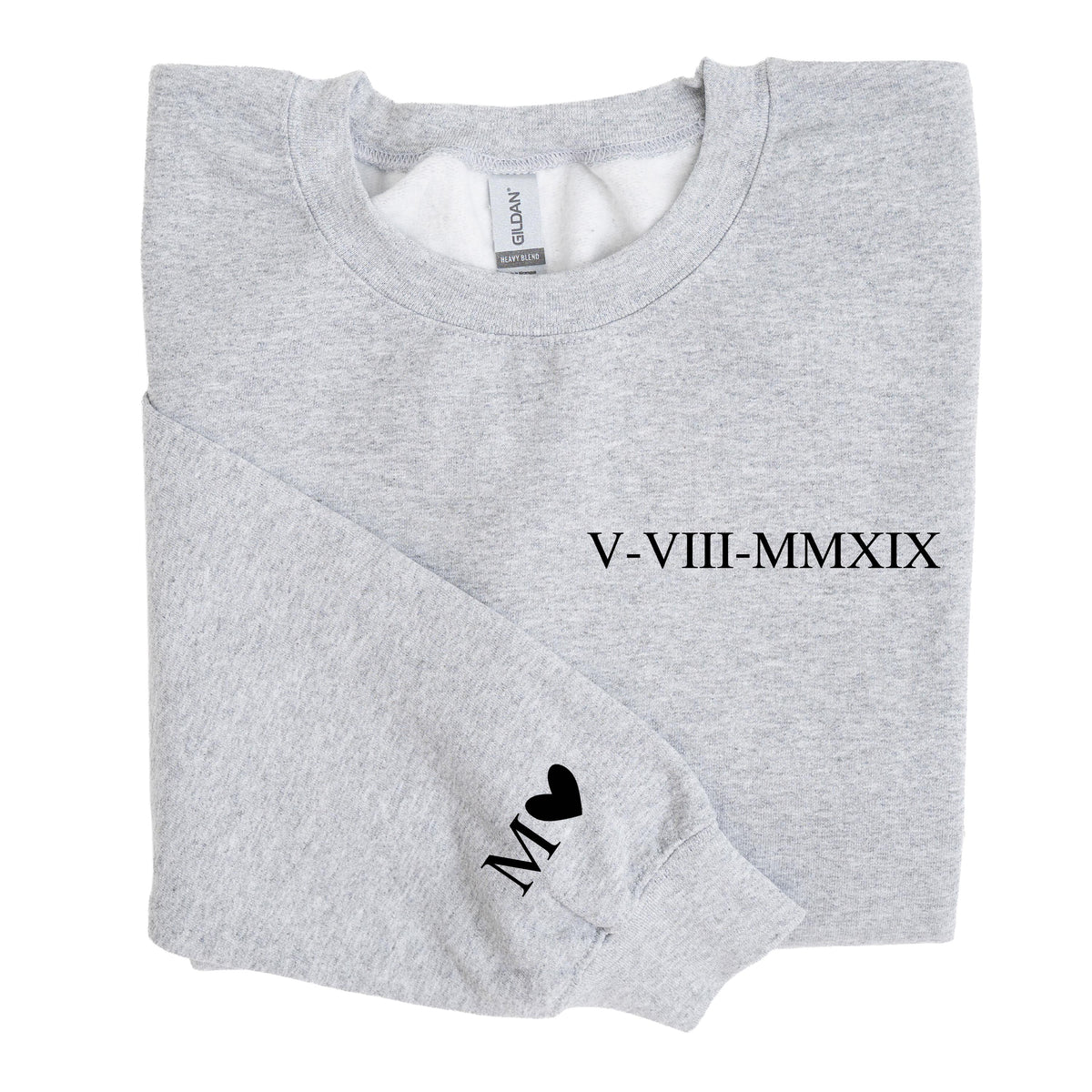 May include: A light gray crewneck sweatshirt featuring the black Roman numeral date V-VIII-MMXIX printed on the chest. The left sleeve displays the letter M followed by a small black heart symbol. The garment has a standard ribbed collar and cuffs.