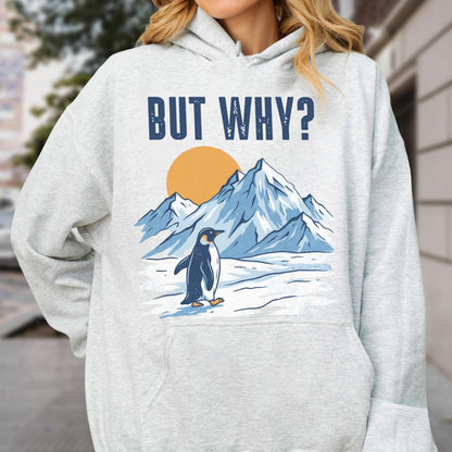 May include: A light gray hoodie featuring a graphic of a penguin in front of a mountain range and a sun. The text "BUT WHY?" is above the graphic in navy blue block letters. The hoodie has a drawstring hood and a kangaroo pocket.
