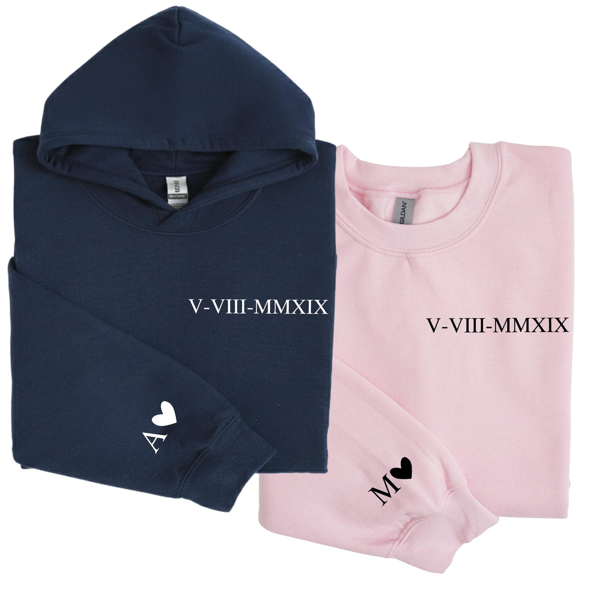 May include: A navy blue hooded sweatshirt and a light pink crewneck sweatshirt. The navy hoodie features the white text V-VIII-MMXIX and a white letter A with a heart. The pink sweatshirt features black text V-VIII-MMXIX and a black letter M with a heart.