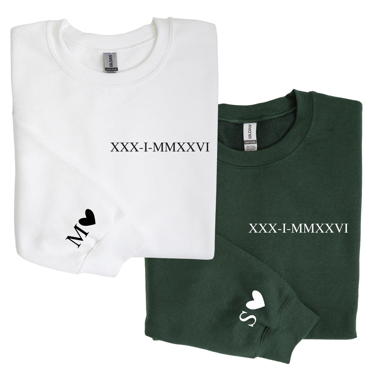 May include: A white sweatshirt with black text reading XXX-I-MMXXVI and a black letter M with a heart on the sleeve, alongside a dark green sweatshirt with white text reading XXX-I-MMXXVI and a white letter S with a heart on the sleeve.
