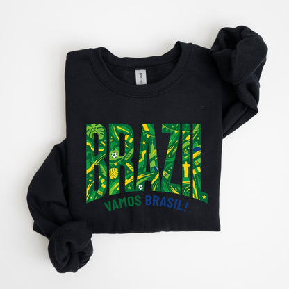 May include: Black sweatshirt with the word "BRAZIL" in large, green and yellow letters. The letters are filled with a tropical pattern. Below the word "BRAZIL" is the phrase "VAMOS BRASIL!" in blue.