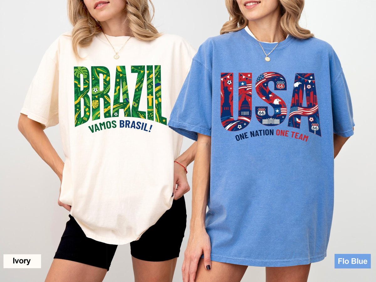 May include: Two oversized t-shirts. One is ivory with "BRAZIL" in green and yellow, and "VAMOS BRASIL!" below. The other is blue with "USA" in red and blue, with "ONE NATION ONE TEAM" below. Both shirts have short sleeves.