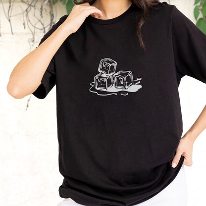 May include: Black t-shirt featuring a graphic of three melting ice cubes in a minimalist style. The ice cubes are white with gray shading, and the melting water is also gray. The shirt is a classic crew neck.