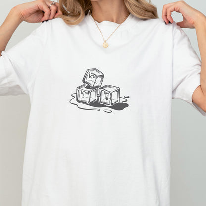May include: White t-shirt featuring a graphic of three melting ice cubes in shades of gray. The design is a simple illustration, with the ice cubes stacked and the water forming around them. The shirt is a casual, everyday wear item.