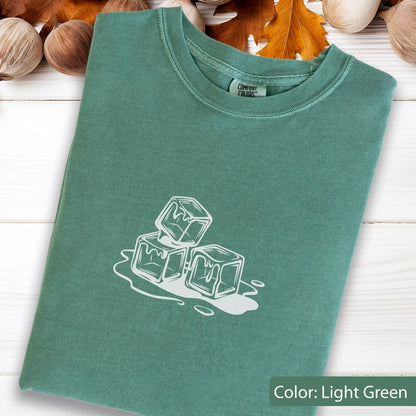 May include: Light green t-shirt with a white graphic of three ice cubes. The shirt is made of a soft material and has a crew neck. The text "Color: Light Green" is at the bottom right of the image.