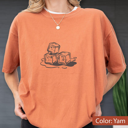 May include: Orange-colored t-shirt with a graphic of three melting ice cubes. The shirt has short sleeves and a crew neck. The text "Color: Yam" is at the bottom right of the image.