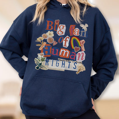 May include: Navy blue hoodie with the phrase "Big Fan of Human Rights" in a collage style. The design includes a rainbow, hearts, flowers, and a raised fist. The hoodie has a front pocket and a hood.