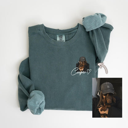 May include: A teal-colored sweatshirt with a custom graphic of a dog wearing a hat and sunglasses. The dog's name, "Cooper", is written in cursive below the graphic, with a heart symbol. The sweatshirt has long sleeves and a crew neck.