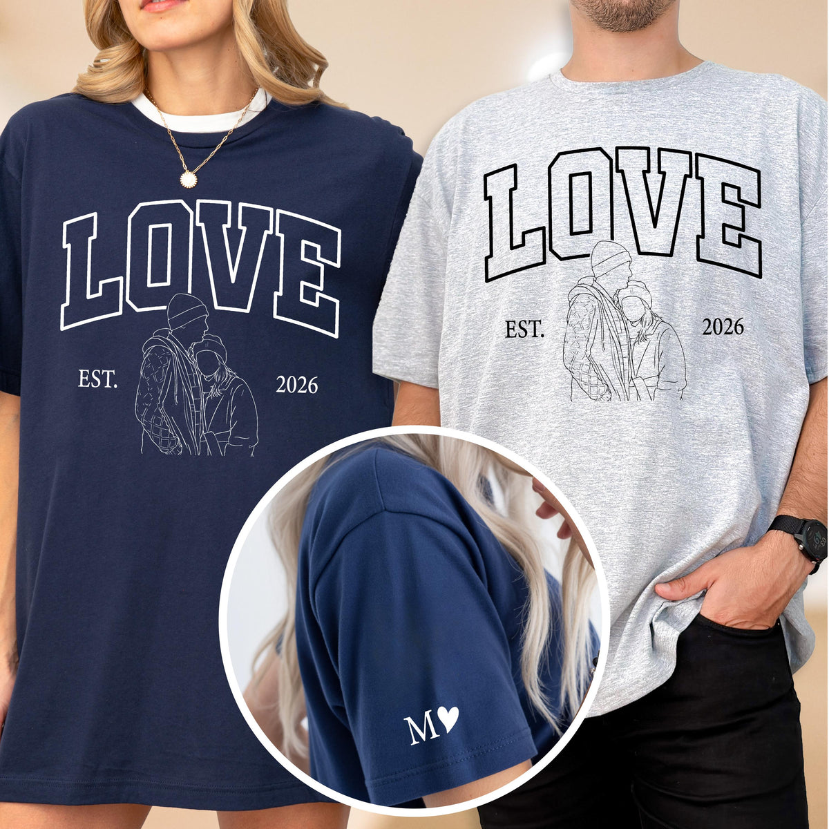May include: Navy blue and gray t-shirts with the word "LOVE" in white block letters. Each shirt has a line drawing of a couple and the text "EST. 2026". The navy shirt has "M ♥" on the sleeve.
