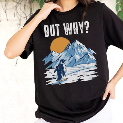 May include: Black t-shirt with a graphic of a penguin in a snowy landscape, mountains, and a sun. The text "BUT WHY?" is printed above the graphic in white.