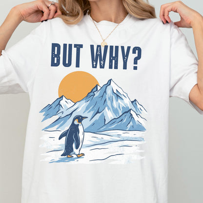 May include: White t-shirt with the text "BUT WHY?" above a graphic of a penguin standing in front of snow-covered mountains and a yellow sun. The penguin is black and white, and the mountains are blue.
